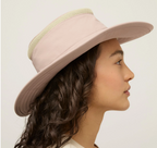 A woman in side profile wearing a light mauve wide-brim sun hat with a textured beige mesh band, photographed against a clean off-white background.