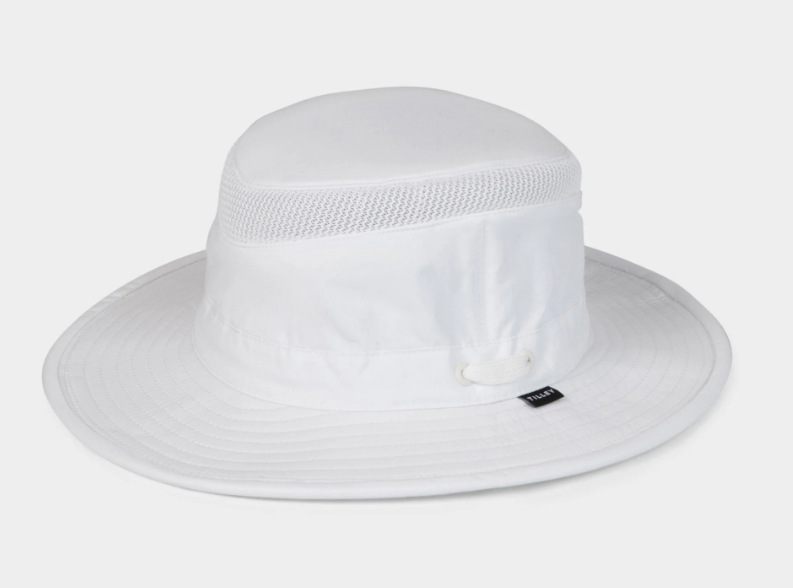 A white wide-brim sun hat with a mesh band around the crown and a small black Tilley Logo the side, photographed against a light gray studio background.